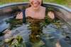 Woman soaking in a bath with seaweed bath soak. Description: This image shows a woman soaking in a bath with seaweed bath soak. The seaweed bath soak is made with nutrient-dense sea kelp and solar-dried Maine sea salt. It is a natural way to detoxify the body, relieve dry skin, and alleviate sore muscles.