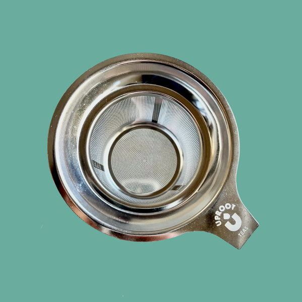 A close-up of the Uproot Teas Stainless Steel Strainer