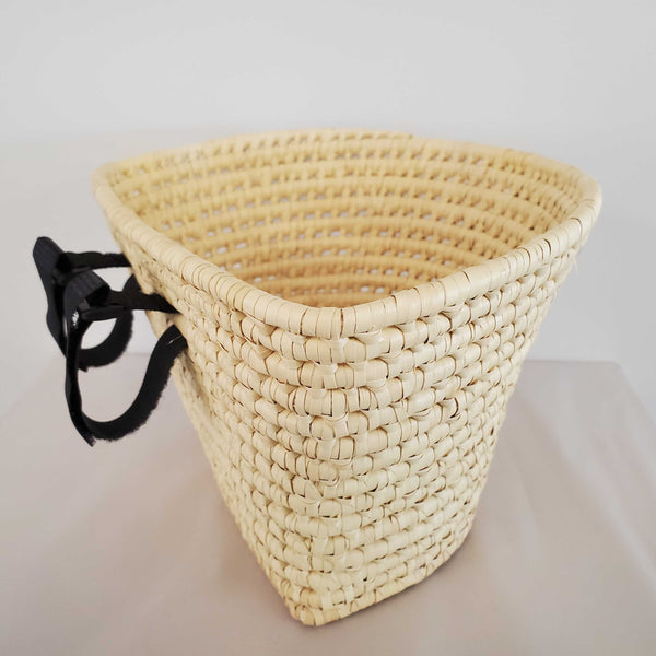 Kid-sized adventure awaits! Sustainable palm leaf bike basket for children. Adjustable, handcrafted in Haiti. Eco-friendly fun & unique gift. Shop now & let imaginations ride! ✨