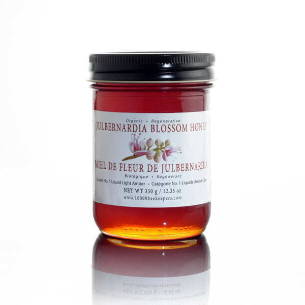 Jar of Ethical Trade Co Organic Julbernardia Blossom Honey on a white background