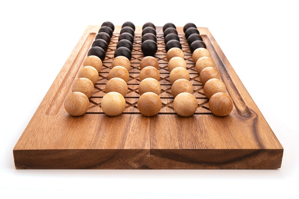 Fanorona wooden strategy board game set displayed on a table in Brooklyn, New York