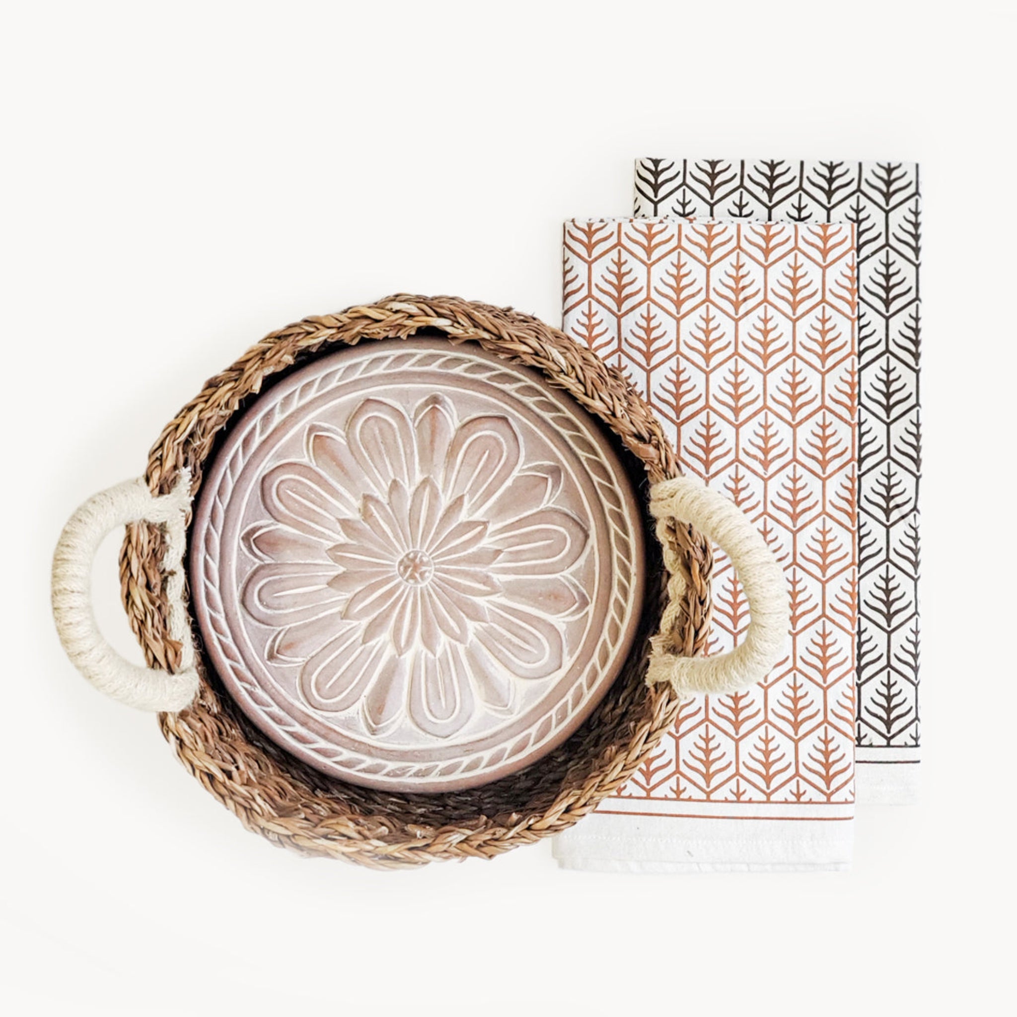 Decorative plate with floral design in a woven basket on a white background