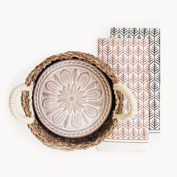 Decorative plate with floral design in a woven basket on a white background