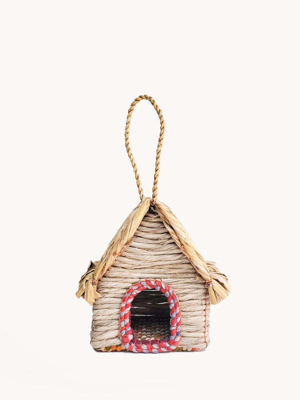 Woven birdhouse with a rope handle on a white background