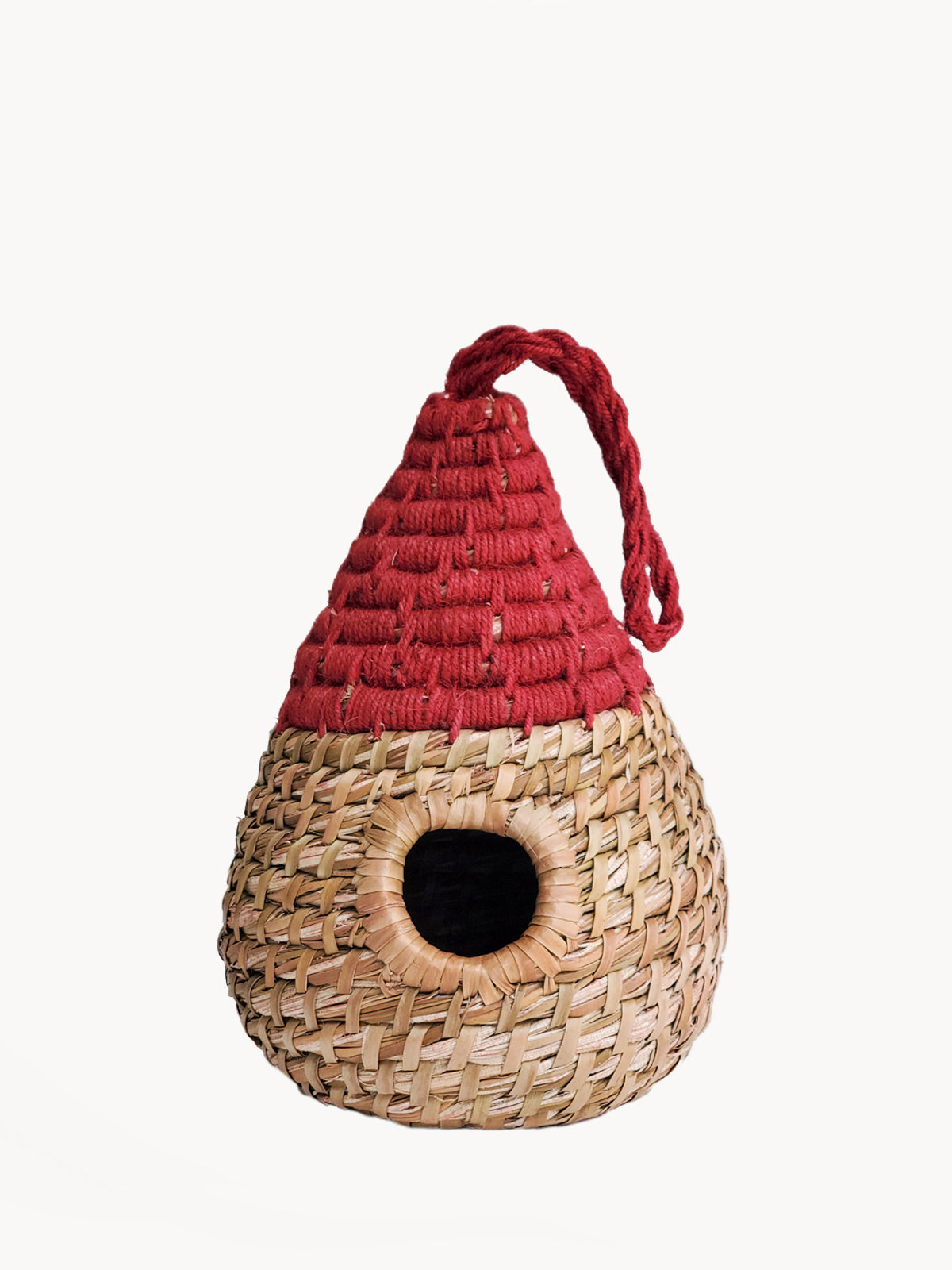 Woven birdhouse with a red roof on a white background