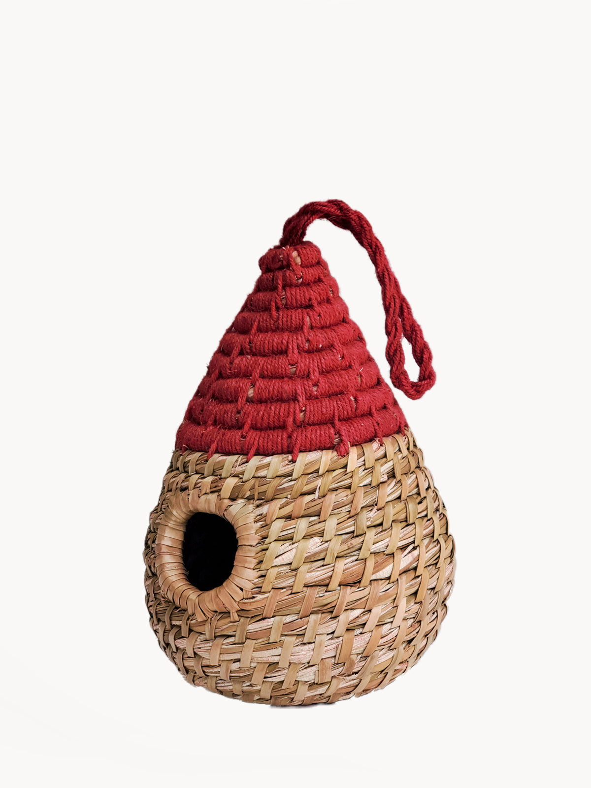 Woven birdhouse with a red roof on a white background