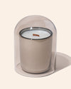 Translucent dove cloche covering a candle on display for retail or market setup