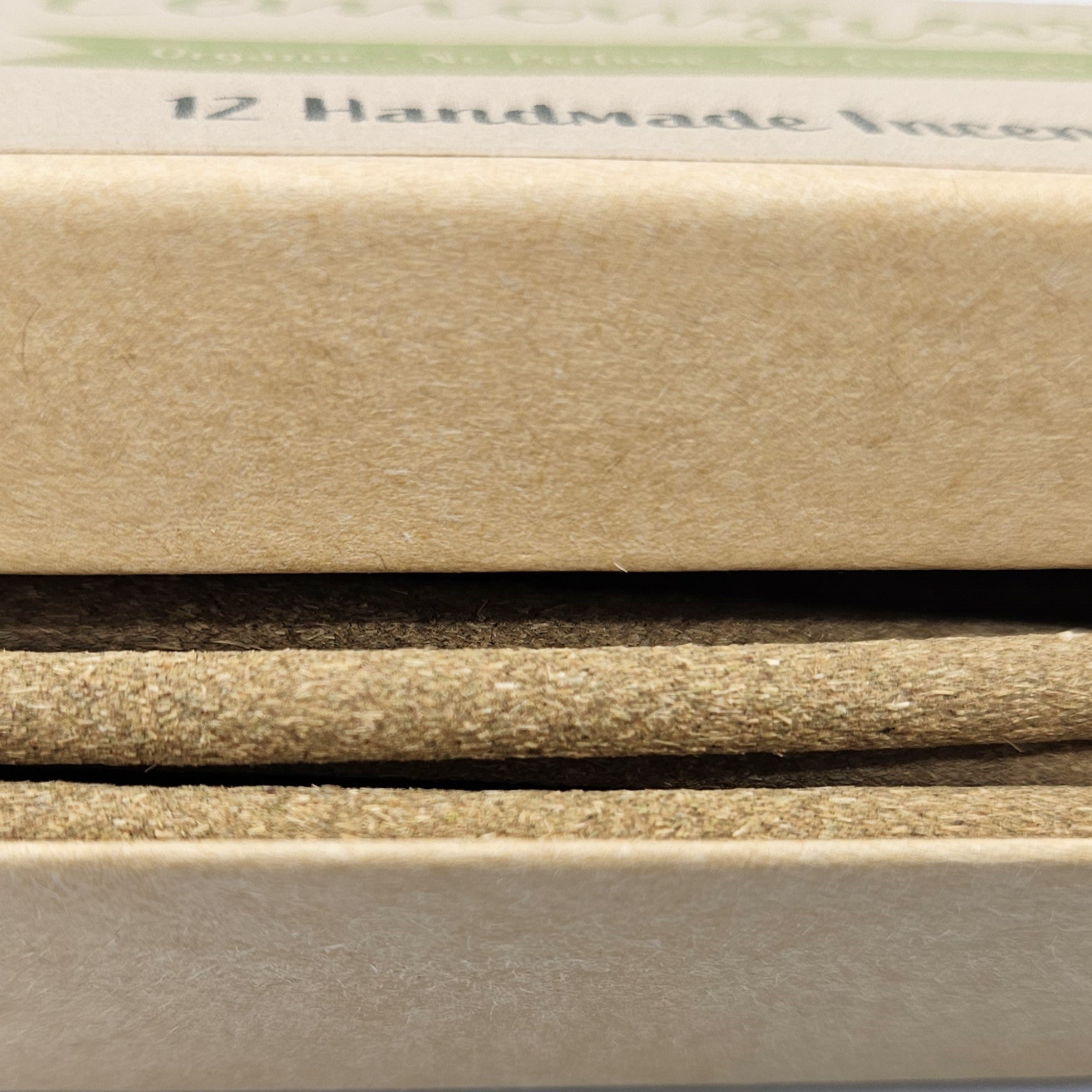 Close-up of various beige and brown paper samples with '12 Handmade' text.