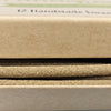 Close-up of various beige and brown paper samples with '12 Handmade' text.