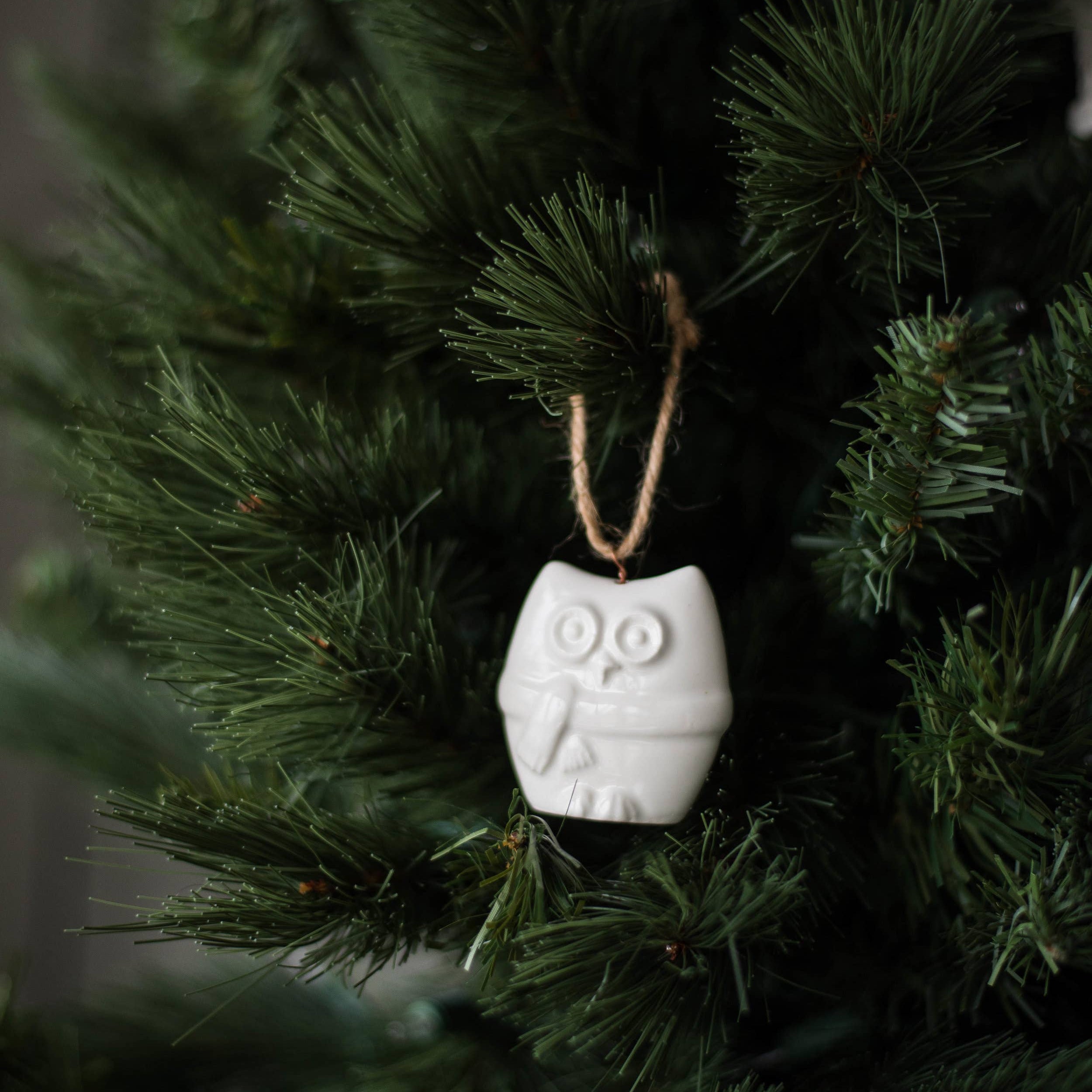 Detail of handcrafted porcelain ornament showing smooth glazed finish and rustic jute loop