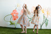 Young child in organic cotton flutter dress with gathered waist and twirl-ready skirt in Summer Bounty print
