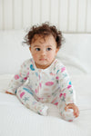 Baby wearing the Seaside Treasures bamboo zip footie romper with ocean-themed print
