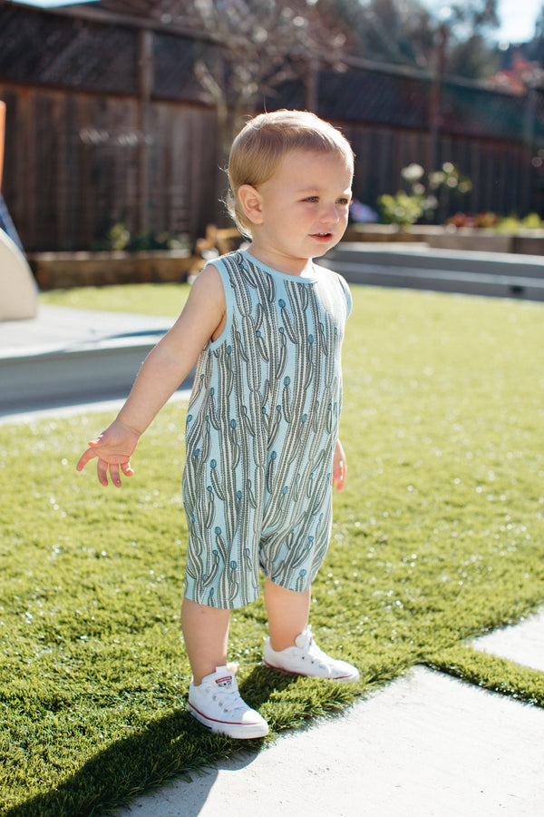 Close-up of Blooming Saguaro bamboo blend baby romper showing cactus illustration print detail