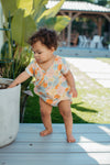 Close-up of Wildflower Picnic organic cotton muslin baby romper showing floral print detail and side snap