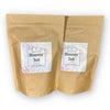 Two brown paper bags with 'Bloomin' Soil' labels on a white background