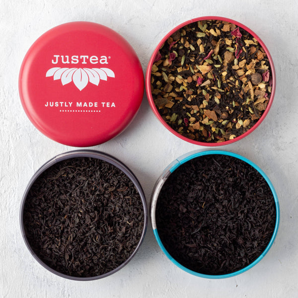 Hand-carved olive-wood tea spoon attached to a JusTea tin – made by Kenyan artisans
