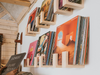 Vinyl records on wooden shelves against a white wall