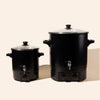 makesy® candle wax melter with stainless steel spout alongside candle vessels and making supplies