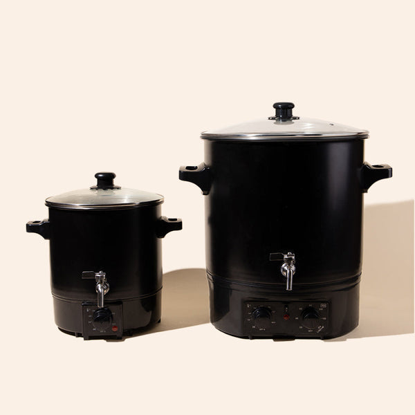 makesy® candle wax melter with stainless steel spout alongside candle vessels and making supplies