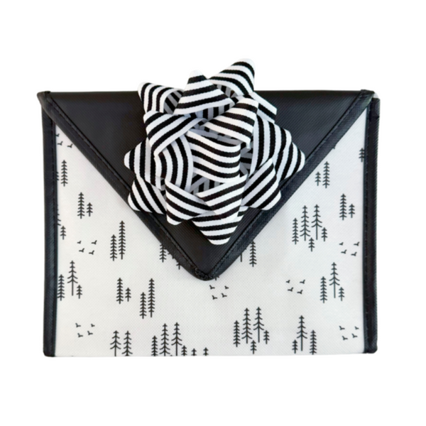 Flat lay of EverBow black grosgrain bow — sustainable reusable gift wrapping accessory