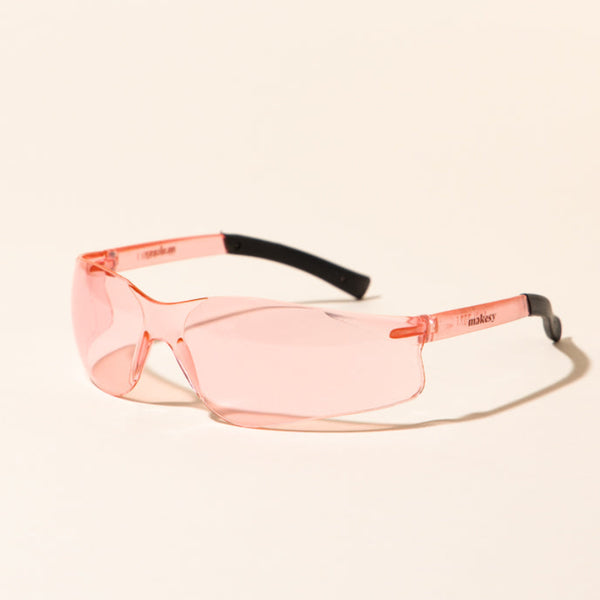 makesy® pink safety glasses with scratch-resistant wrap-around lens and non-slip rubber grips, front view