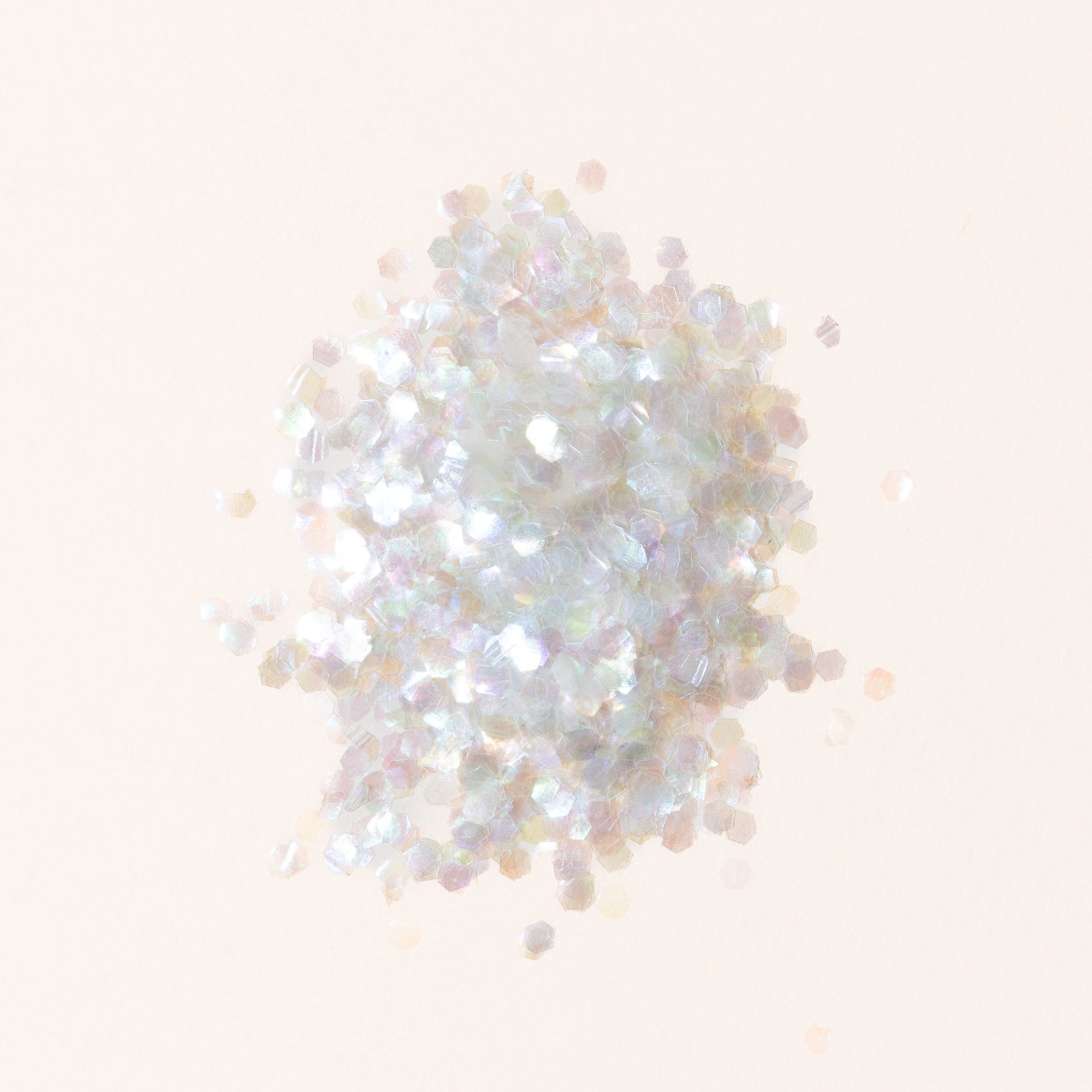 White glitter on a light beige background