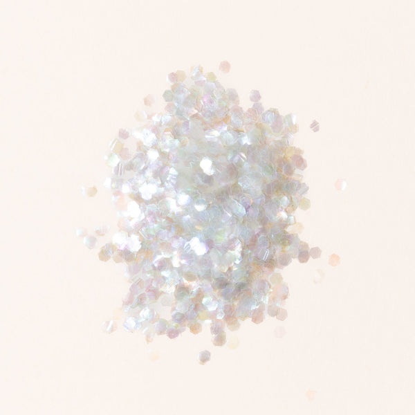 White glitter on a light beige background