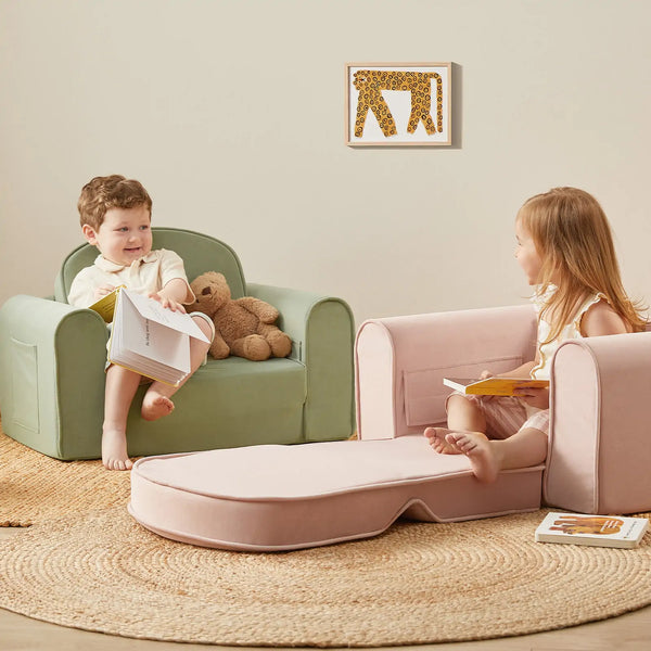Child sitting on Tiny Land GentleSnug sage kid sofa chair in a playroom
