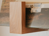Close-up of Deep Cut Flip Record Display Shelf hardwood bracket showing grain detail and branding