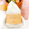 Organic relaxation bath tea blend with dried chamomile, lavender, and rose petals in a muslin sachet bag by Butter Me Up Organics
