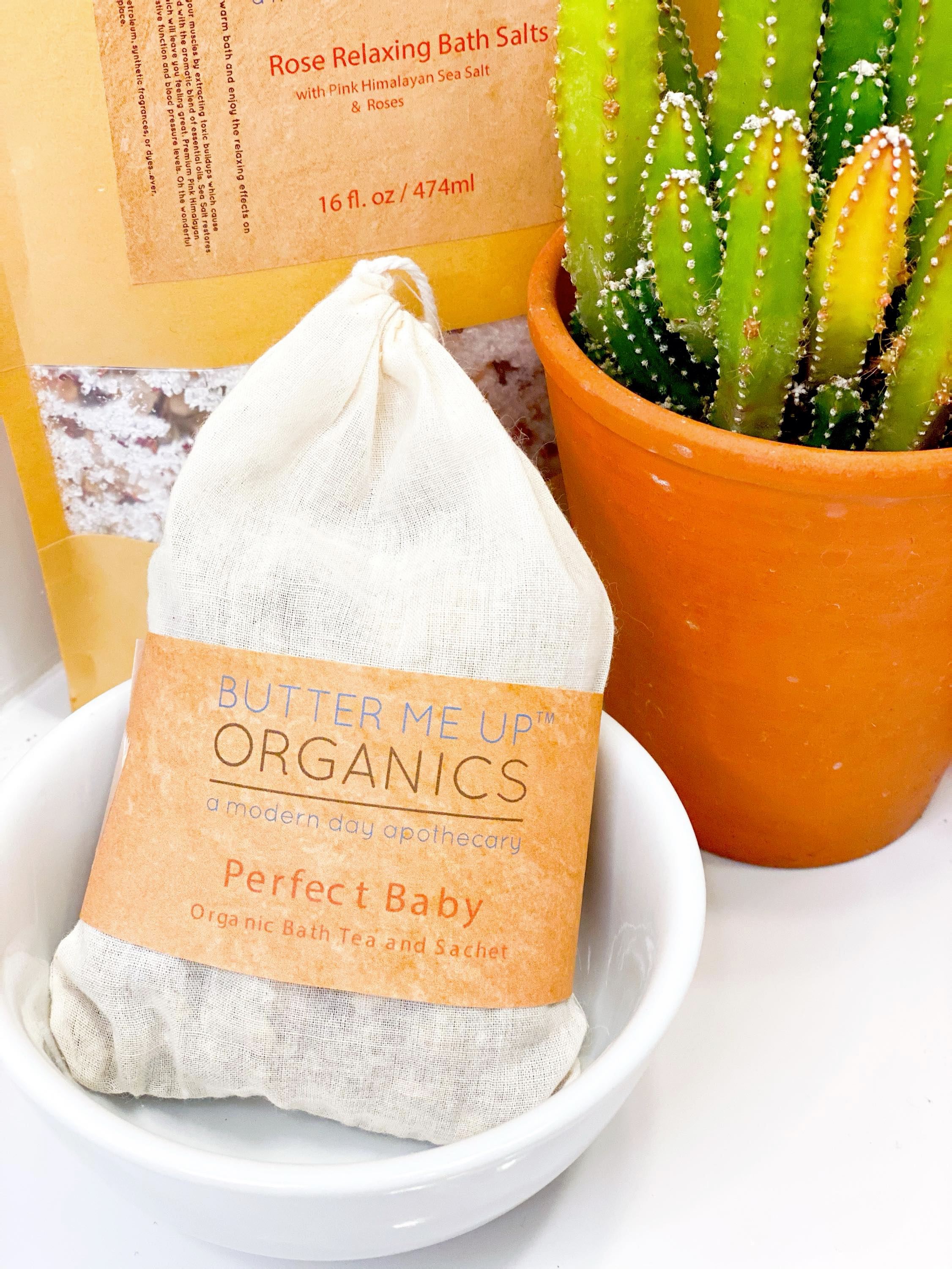 Flat lay of organic baby bath tea sachet ingredients including lavender, rose, chamomile and calendula flowers