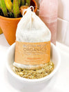 Muslin bath tea sachet filled with organic herbs including oatstraw and lemon peel