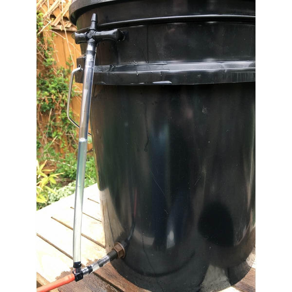 Gravity-fed Blumat drip irrigation reservoir with visible water level gauge