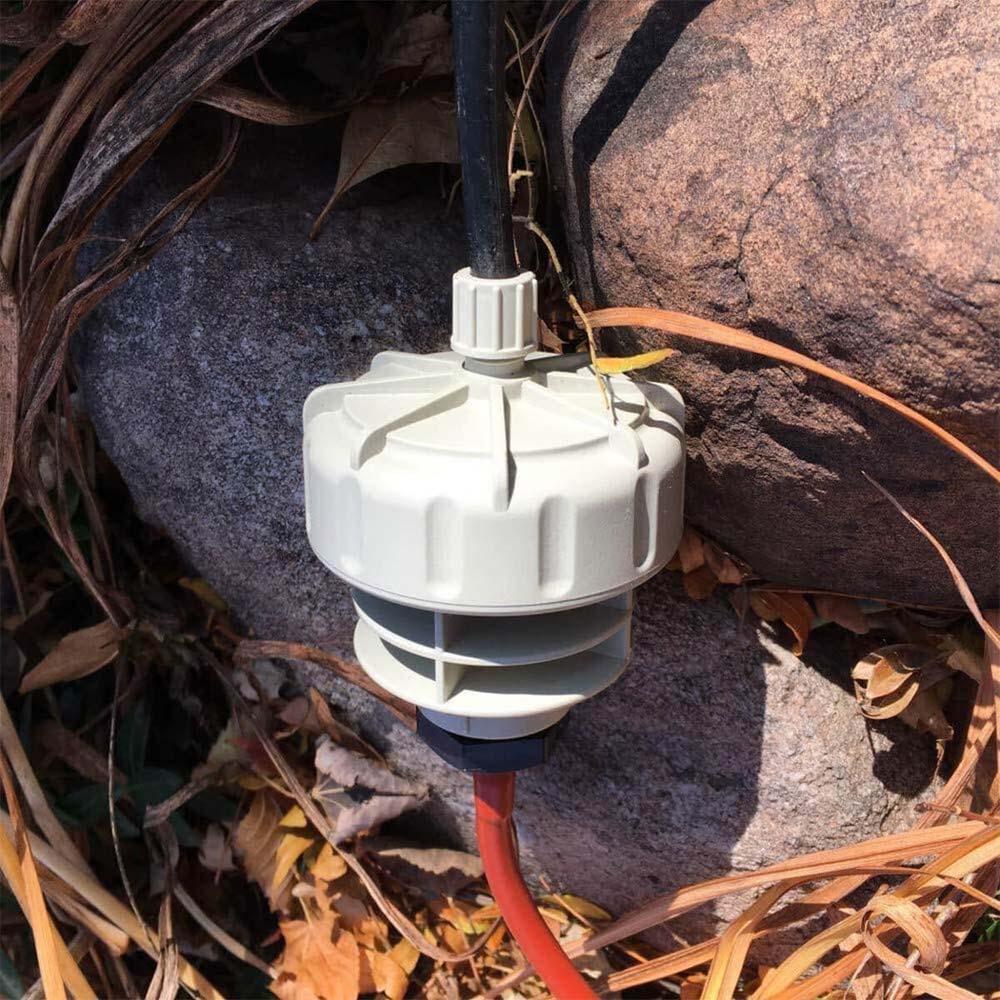White mechanical device with red cable on a rocky surface