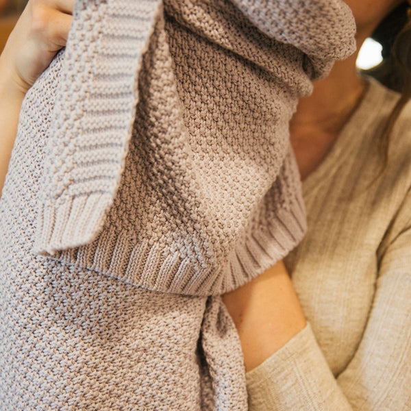 Close-up of Thistle knitted baby blanket showing soft cotton texture and stitch detail by Plum+Sparrow