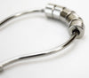 Close-up of flat roller shower curtain rings showing hoop opening and metal construction
