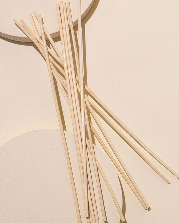 Rattan diffuser reeds styled in a home setting for aromatherapy fragrance diffusion