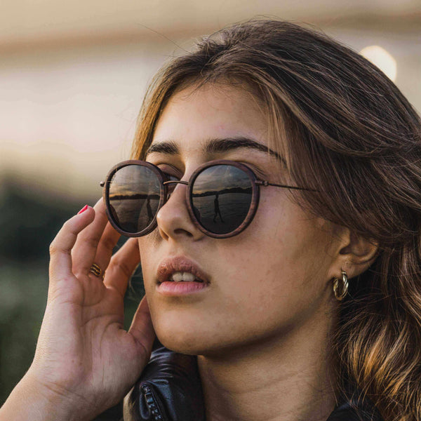 Woman wearing sunglasses with a blurred background