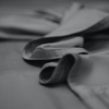 Close-up of a gray fabric with a belt on a dark background