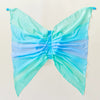 Gradient blue and green butterfly costume on a light beige background