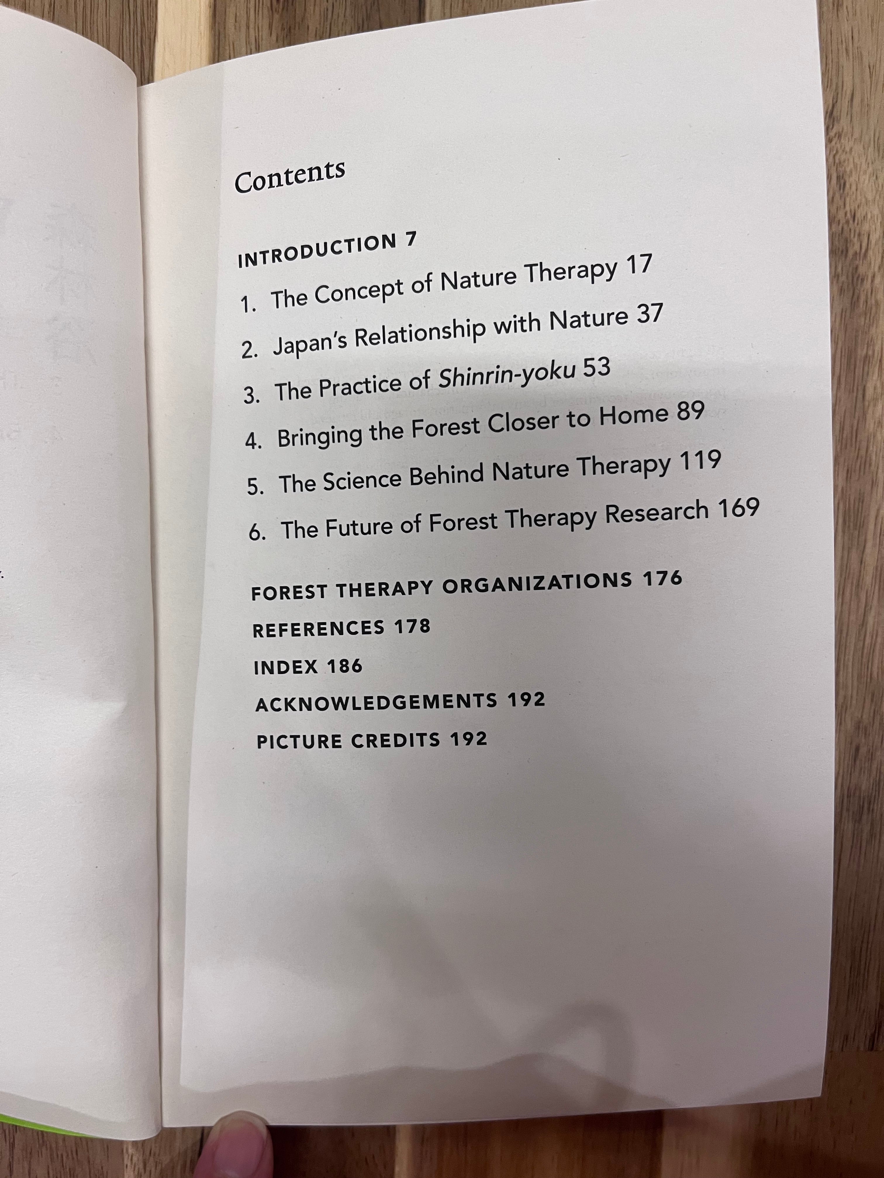 Table of contents page of a book on a wooden surface