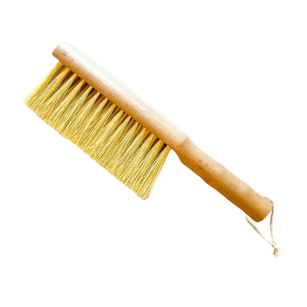Close-up of natural sisal bristles on a solid beechwood gardener's brush by Seattle Seed Company