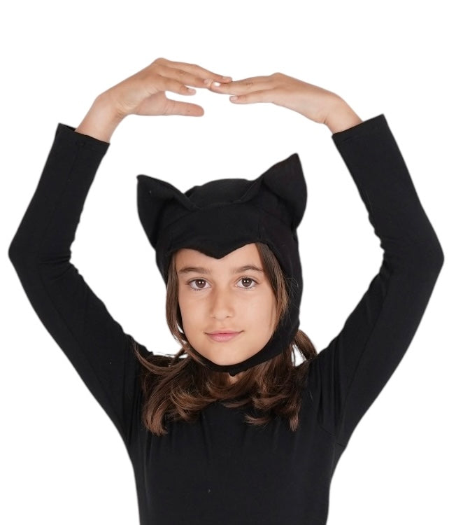 Child wearing a black cat ears headband on a white background