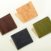 Four square cork wallets in different colors on a light background