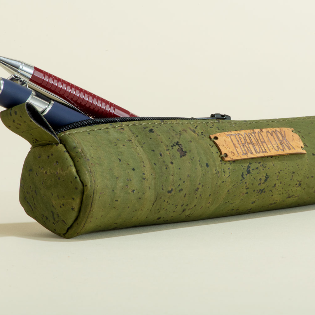 Green cork pencil case with pens on a beige background