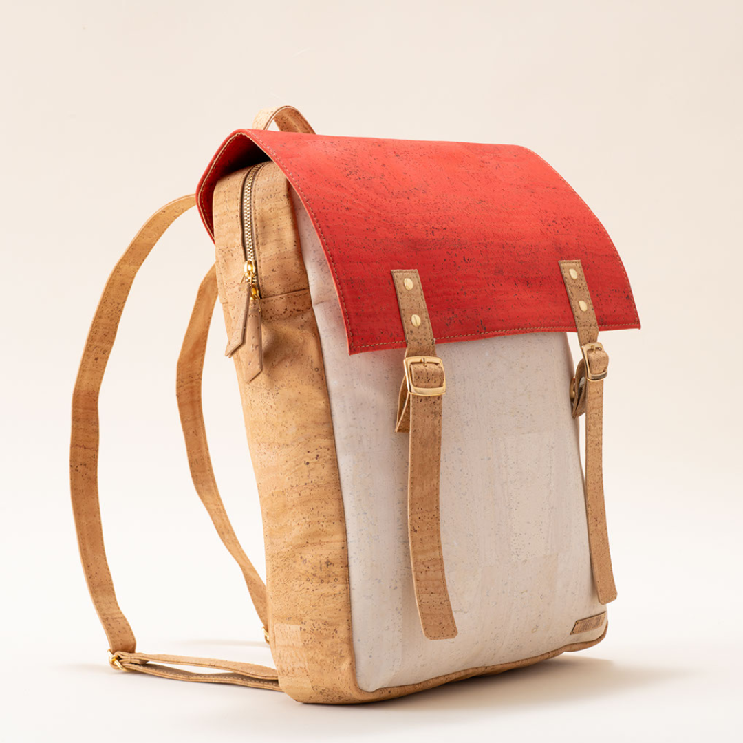 Backpack with red top section and beige sides on a light background