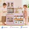 A children's play kitchen set in pastel pink with floral wallpaper, gold-tone faucet and knobs, and white storage bins, shown with two children interacting in a bright room. Three feature badges appear along the bottom.