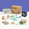 Collection of educational toys and a Montessori play box on a white surface with a blue background