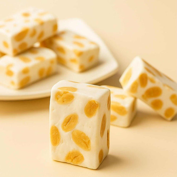 Cubes of white dessert with yellow spots on a beige background