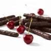 Chocolate-dipped cherries on a white background